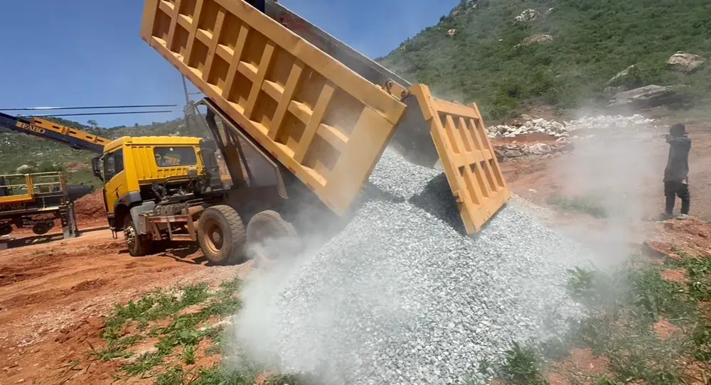 Tipper truck offloading crushed aggregate on site