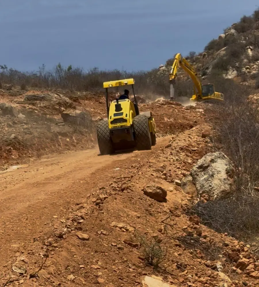 Wheel roller and excavator forming a road